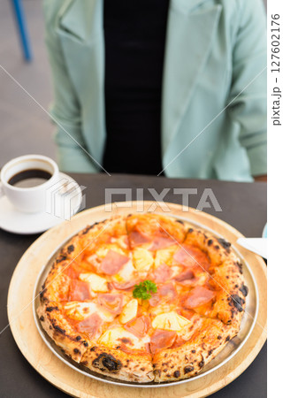 Businessman ready to eat Hawaiian pizza with pineapple and ham 127602176
