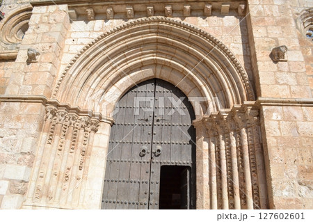 Historic romanesque church doorway in brihuega spain on a sunny day. Iglesia de San Felipe. Church Saint Felipe in Brihuega, Guadalajara, Spain 127602601