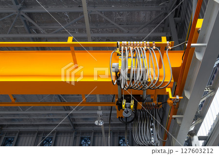 Overhead crane or lifting equipment inside factory or warehouse. Overhead crane or lifting equipment inside factory or warehouse. 127603212