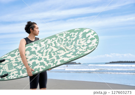 海辺でサーフィンに挑む若者のポートレート 海辺でサーフィンに挑む若者のポートレート 127603273