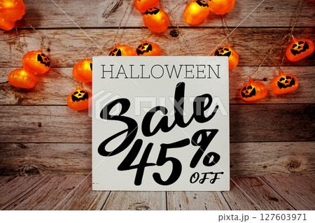 Halloween Sale 45% off text with LED pumpkin decoration on wooden background Halloween Sale 45% off text with LED pumpkin decoration on wooden background 127603971