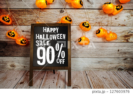 Halloween Sale 10% off text with LED pumpkin decoration on wooden background 127603976