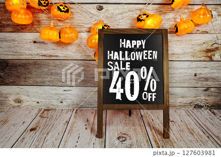 Halloween Sale 40% off text with LED pumpkin decoration on wooden background 127603981