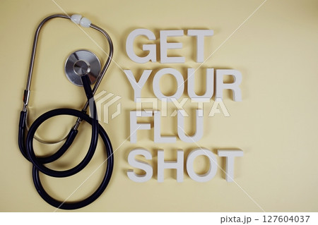 Get Your Flu Shot alphabet letters with stethoscope top view on yellow background Get Your Flu Shot alphabet letters with stethoscope top view on yellow background 127604037