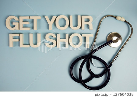 Get Your Flu Shot alphabet letters with stethoscope top view on blue background Get Your Flu Shot alphabet letters with stethoscope top view on blue background 127604039