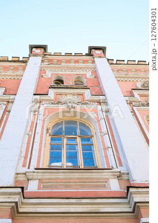 Architectural detail of historic building with ornate window, decorative elements Low angle 127604301