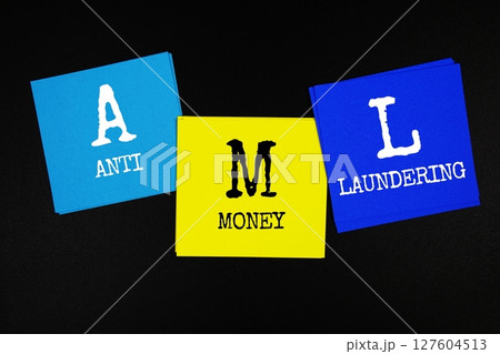 AML - Anti Money Laundering acronym text on sticky note on black background AML - Anti Money Laundering acronym text on sticky note on black background 127604513
