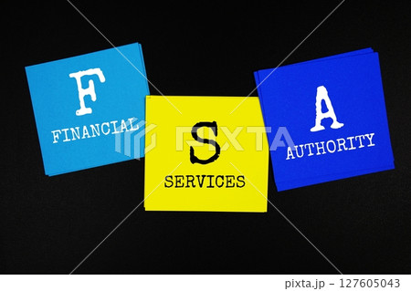 FSA - Financial Services Authority acronym text on sticky note on black background 127605043