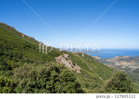 A Beautiful and Scenic Coastal Landscape Featuring Lush Green Hills Under Clear Blue Skies A Beautiful and Scenic Coastal Landscape Featuring Lush Green Hills Under Clear Blue Skies 127605112