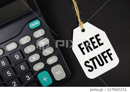 Free Stuff text on price tag with calculator on black background 127605231