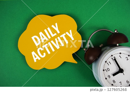 Daily Activity text on speech bubble with alarm clock on green background 127605268