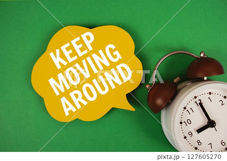 Keep Moving Around text on speech bubble with alarm clock on green background 127605270