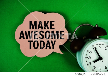 Make Awesome Today text on speech bubble with alarm clock on green background 127605274