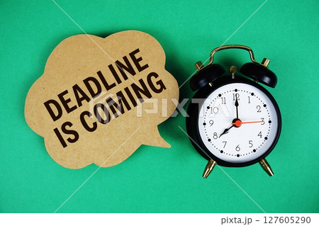 Deadline Is Coming text on speech bubble with alarm clock on green background 127605290