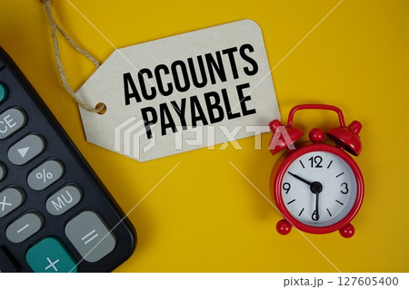 Account Payable text on price tag with calculator on yellow background 127605400