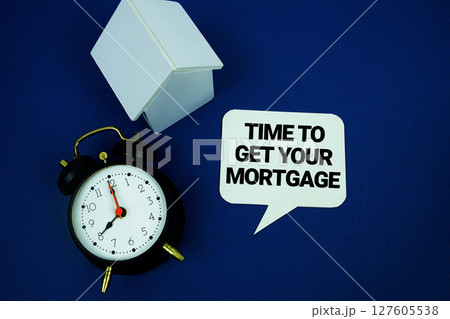 Time to Get Your Mortgage text with alarm clock and house model top view on blue background 127605538
