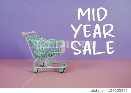 Mid Year Sale text with trolley shopping cart on purple and pink geometric background Mid Year Sale text with trolley shopping cart on purple and pink geometric background 127605545