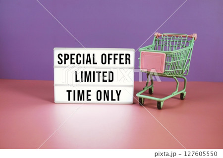 Special Offer Limited Time Only text on LED lightbox with trolley shopping cart on pink and purple geometric background Special Offer Limited Time Only text on LED lightbox with trolley shopping cart on pink and purple geometric background 127605550