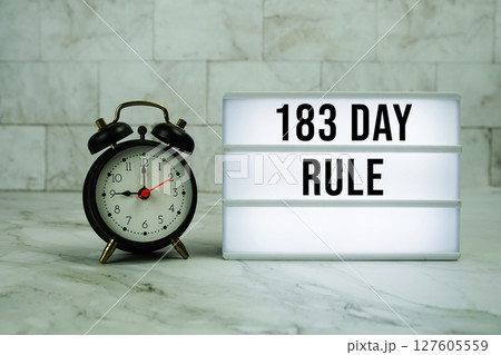 183 Day Rule text on LED lightbox with alarm clock on marble background 127605559