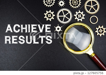 Achieve Results text message with magnifying glass on black background 127605756