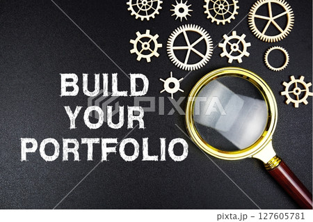 Build Your Portfolio text message with magnifying glass on black background 127605781