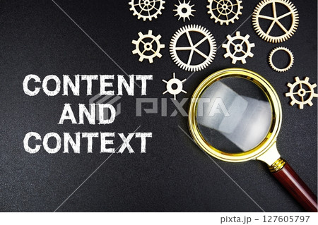 Content And Context text message with magnifying glass on black background Content And Context text message with magnifying glass on black background 127605797