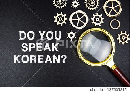 Do You Speak Korean? text message with magnifying glass on black background Do You Speak Korean? text message with magnifying glass on black background 127605815