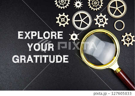 Explore Your Gratitude text message with magnifying glass on black background Explore Your Gratitude text message with magnifying glass on black background 127605833