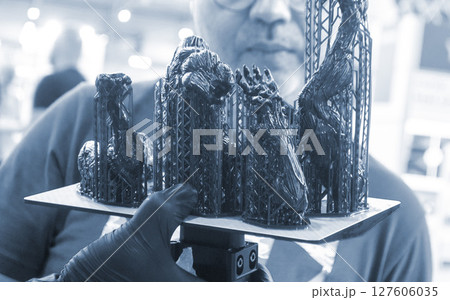 An object printed on a 3D printer from hardened rubber close-up. Model black color created on a 3D printer from hardened rubber under influence of ultraviolet light. SLA 3D printing. Stereolithography An object printed on a 3D printer from hardened rubber close-up. Model black color created on a 3D printer from hardened rubber under influence of ultraviolet light. SLA 3D printing. Stereolithography 127606035