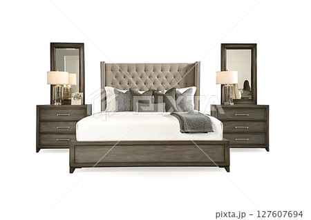 A bed set with a grey headboard and a white bedspread 127607694
