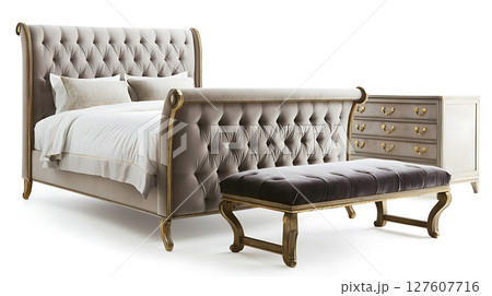 A bed with a white comforter and pillows, a black footstool A bed with a white comforter and pillows, a black footstool 127607716