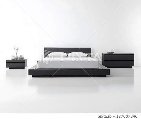 A black bed with white pillows 127607846