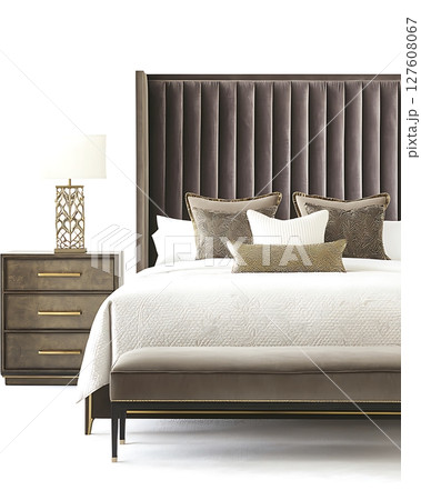 A bed with a white comforter and pillows, a nightstand with a lamp 127608067