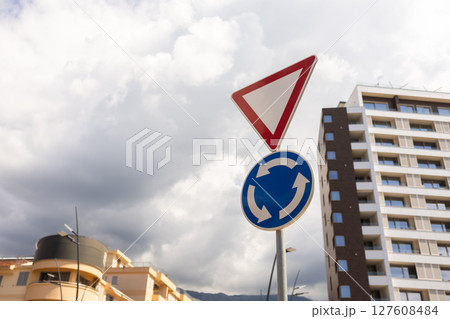 Road signs with modern buildings in background. Urban navigation, city traffic control, and modern infrastructure. 127608484
