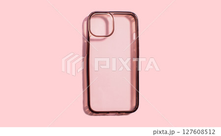 Transparent phone case on pink background, highlighting its old and dirty surface and dark sides. Usage of protection device for long time Transparent phone case on pink background, highlighting its old and dirty surface and dark sides. Usage of protection device for long time 127608512
