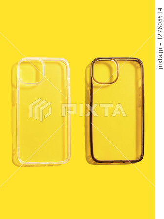 Comparison of transparent phone cases, one clean and one dirty, displayed on bright yellow background, illustrating the impact of daily use of mobile accessories. 127608514