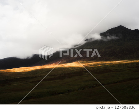 View of carrauntoohill mountain in ireland during daytime with clouds blanketing the summit area of the rugged landscape. 127608836