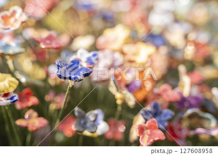 A Beautiful Array of Colorful Blooming Flowers Set in a Lush and Inviting Garden Environment 127608958