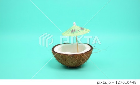 Half coconut shell on turquoise background 127610449