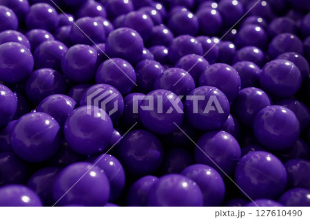 Closeup of many purple plastic balls in soft light, top view Closeup of many purple plastic balls in soft light, top view 127610490