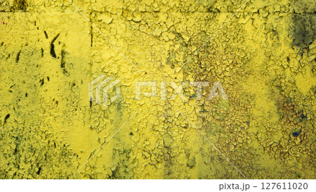 Weathered yellow painted wall close-up texture 127611020