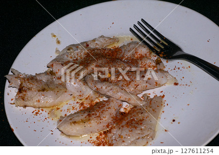 Hake fillets on a white plate 127611254