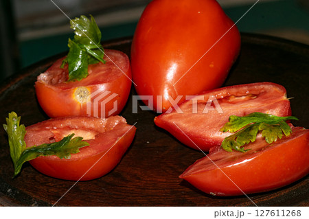 Fresh tomato and parsley , on a chopping board 127611268
