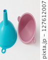 Colorful plastic kitchen funnels pink and blue plastic funnels on white background Colorful plastic kitchen funnels pink and blue plastic funnels on white background 127612007