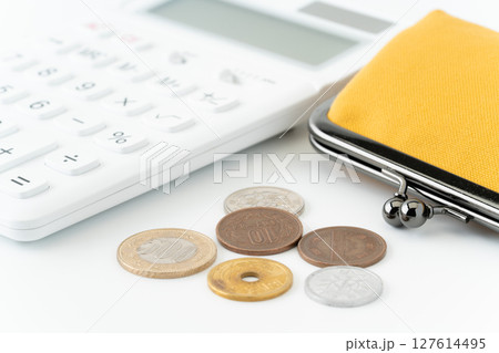 白背景に電卓と黄色のがま口財布と硬貨（日本） 127614495