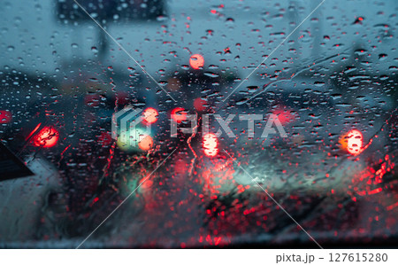 Rain drop on the car glass window while driving on the road. 127615280