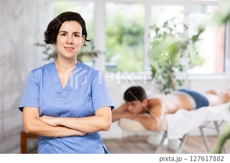 Adult female masseuse posing in office Adult female masseuse posing in office 127617882