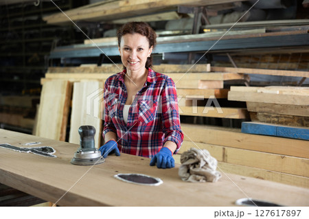 Adult woman posing with oak plank Adult woman posing with oak plank 127617897