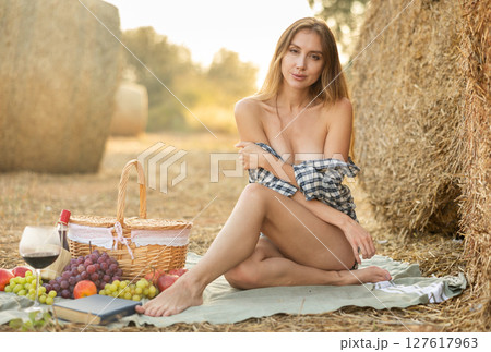 Young woman in shirt sitting during picnic 127617963