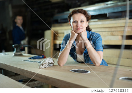 Adult woman posing with oak plank 127618335